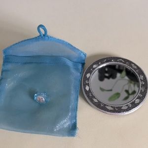 Mirror with geometric shaped flower mirror design in protective pouch